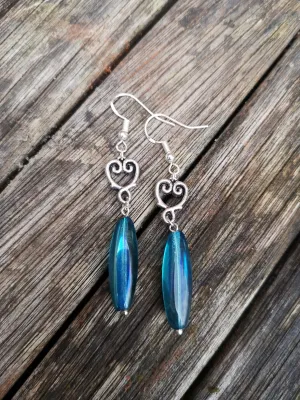 Electra Earrings, long rice shape turquoise fire polished drops with Tibetan heart charm